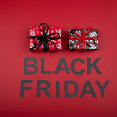 Festive Black Friday promotion with gift boxes on a vibrant red background.